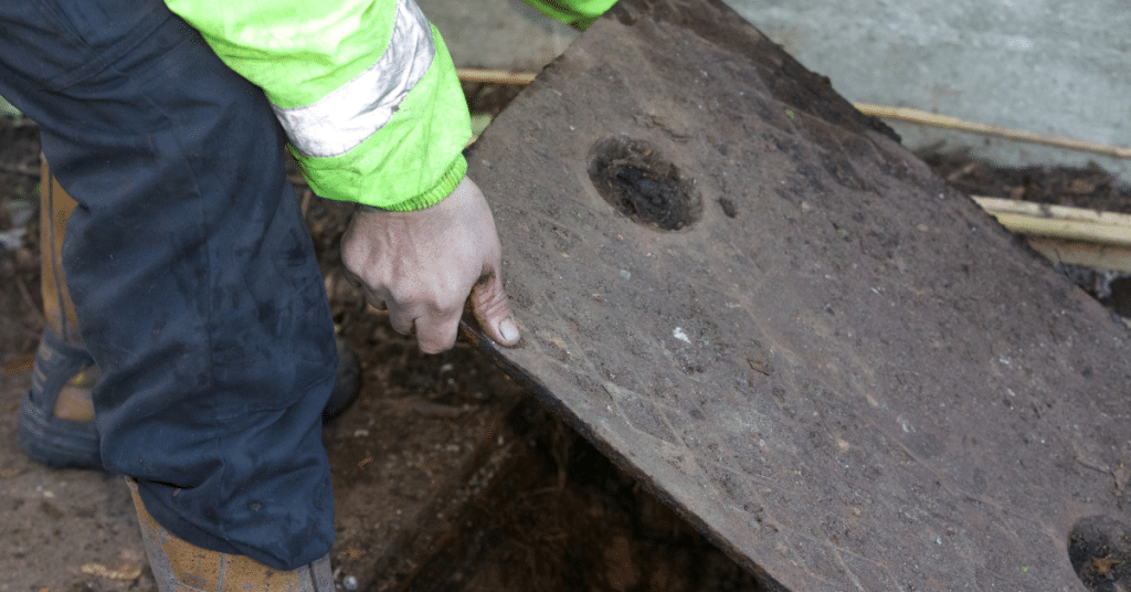 man lifting drain cover to commence drain jetting